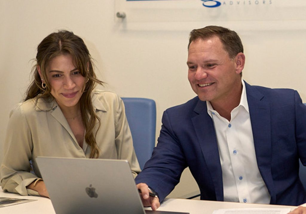 Two team members working on a computer