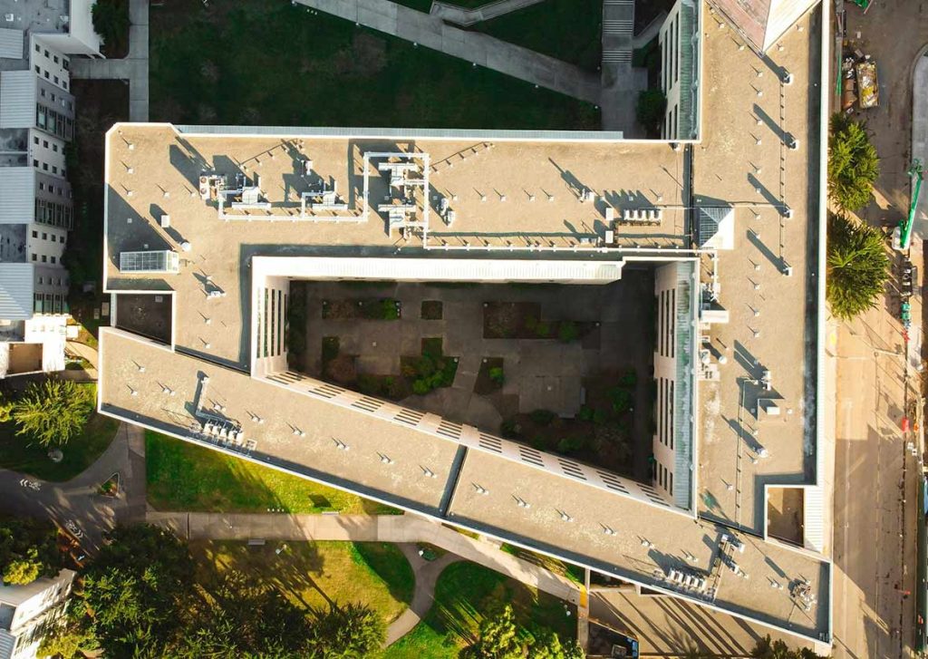 Aerial view of a commercial building rooftop, highlighting structural layout and infrastructure for property risk assessment